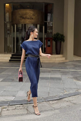 Pleated silk midi dress with boat neckline and waist-defining sash belt for elegant styling