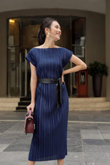 Pleated silk midi dress with boat neckline and waist-defining sash belt for elegant styling