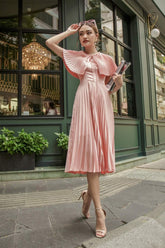 Sleeveless pleated midi silk dress with structured cape and cinched waist