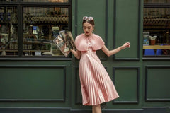 Sleeveless pleated midi silk dress with structured cape and cinched waist