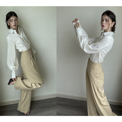 Silk blouse with tailored collar, voluminous sleeves, and pearl-detailed buttoned cuffs