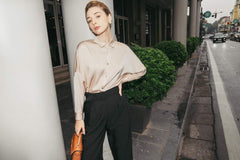 Tailored silk wide-leg pants with high-rise waist and pleated front for elegant drape