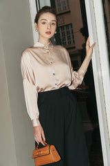 Tailored silk wide-leg pants with high-rise waist and pleated front for elegant drape