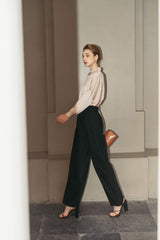 Tailored silk wide-leg pants with high-rise waist and pleated front for elegant drape