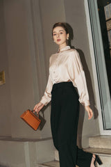 Tailored silk wide-leg pants with high-rise waist and pleated front for elegant drape