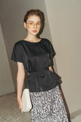 Short-sleeve silk blouse with boat neckline and belted waist for a sculpted silhouette