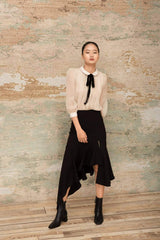 Asymmetric silk midi skirt with front slit and cascading ruffle hem detail