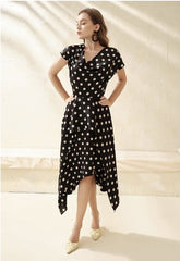 Silk polka dot dress with cowl neckline and asymmetrical hem for a playful feminine look