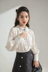 Silk A-line skirt with pearl button accents and structured silhouette for elevated daywear