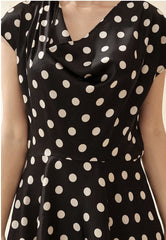 Silk polka dot dress with cowl neckline and asymmetrical hem for a playful feminine look