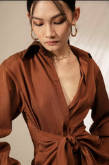 Silk shirt dress with tie-front draping and collared neckline for contemporary elegance