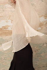 Sheer pleated organza blouse with puff sleeves and velvet bow tie detail