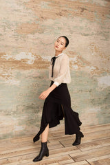 Asymmetric silk midi skirt with front slit and cascading ruffle hem detail