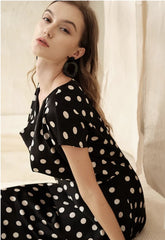 Silk polka dot dress with cowl neckline and asymmetrical hem for a playful feminine look