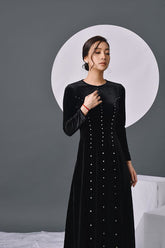 Elegant velvet long-sleeve evening dress with pearl embellishments and flowing silhouette