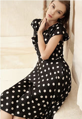 Silk polka dot dress with cowl neckline and asymmetrical hem for a playful feminine look