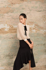 Sheer pleated organza blouse with puff sleeves and velvet bow tie detail