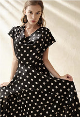 Silk polka dot dress with cowl neckline and asymmetrical hem for a playful feminine look