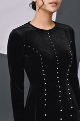 Elegant velvet long-sleeve evening dress with pearl embellishments and flowing silhouette