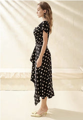 Silk polka dot dress with cowl neckline and asymmetrical hem for a playful feminine look