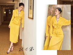 Silk midi dress with front tie detail, deep neckline, and long sleeves for statement evenings
