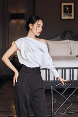 Silk high-waisted tapered pants with pleated front and tailored waistband for elegant structure