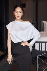 Silk high-waisted tapered pants with pleated front and tailored waistband for elegant structure