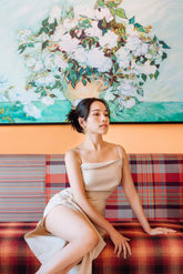 Bias-cut silk dress with ruched detail and thigh-high slit for elegant beach styling