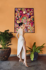 Bias-cut silk dress with ruched detail and thigh-high slit for elegant beach styling