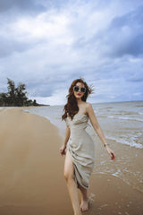 Bias-cut silk dress with ruched detail and thigh-high slit for elegant beach styling