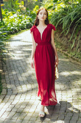 Sleeveless pleated silk maxi dress with ruffle shoulder detail and deep V neckline