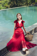 Sleeveless pleated silk maxi dress with ruffle shoulder detail and deep V neckline