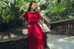 Pleated silk midi dress with soft sheer overlay and gathered waistline for elegant movement