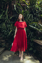 Pleated silk midi dress with soft sheer overlay and gathered waistline for elegant movement