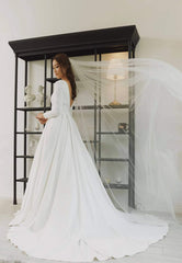 Long sleeve A-line silk dress with boat neckline and open back detailing for formal occasions