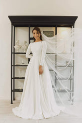 Long sleeve A-line silk dress with boat neckline and open back detailing for formal occasions