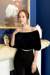 Off-shoulder velvet blouse with elastic neckline and voluminous puff sleeves for statement styling