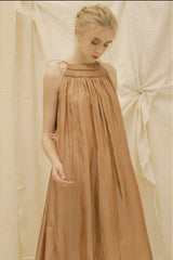 Sleeveless gathered organza dress with relaxed A-line silhouette and tie shoulder detailing