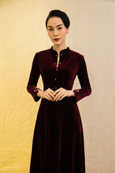 Velvet midi dress with high collar, pearl button details, and fitted long sleeves