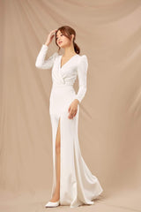 Silk floor-length wrap dress with V-neckline, long sleeves, and dramatic thigh-high slit