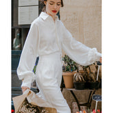 Silk button-down blouse with puff sleeves and wide cuffs for elegant everyday styling