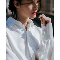 Silk button-down blouse with puff sleeves and wide cuffs for elegant everyday styling