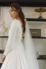 Elegant A-line silk dress with long sleeves and flowing full-length skirt for formal occasions