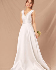 Silk sleeveless V-neck gown with lace-up side detail and full-length flowing A-line skirt
