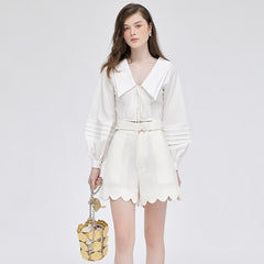 Silk high-waisted shorts with scalloped hem and tailored fit for elevated summer styling