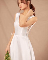 Silk sleeveless V-neck gown with lace-up side detail and full-length flowing A-line skirt