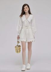 Silk high-waisted shorts with scalloped hem and tailored fit for elevated summer styling