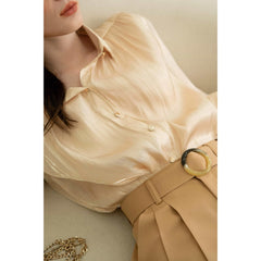 Textured silk blouse with pleated long sleeves and soft sheen finish for elegant styling