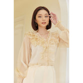Sheer organza blouse with ruffled neckline and smocked cuffs for elegant feminine styling