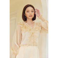 Sheer organza blouse with ruffled neckline and smocked cuffs for elegant feminine styling
